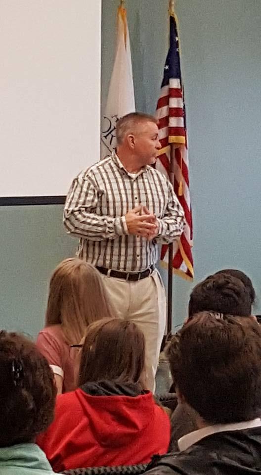 Criminal Justice Instructor Tim Bentley speaking to a class of children