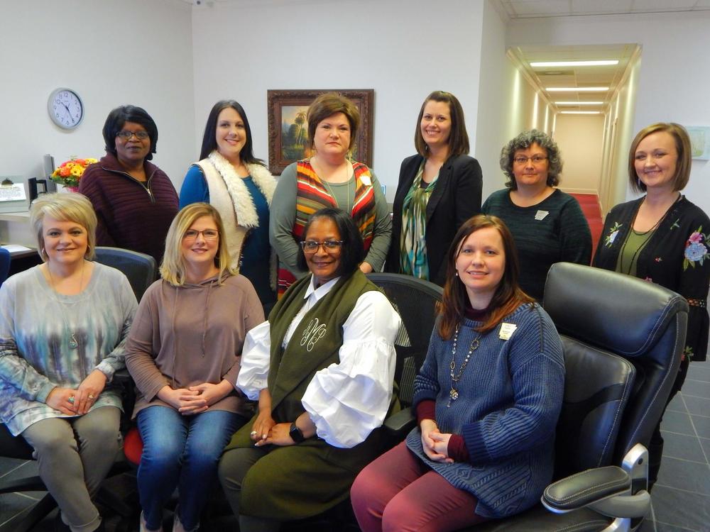 Leslie Mason and seven other Blytheville Circuit Clerk team members smiling for the camera