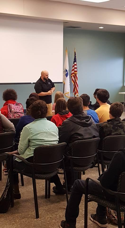 Police officer speaking to a class of children