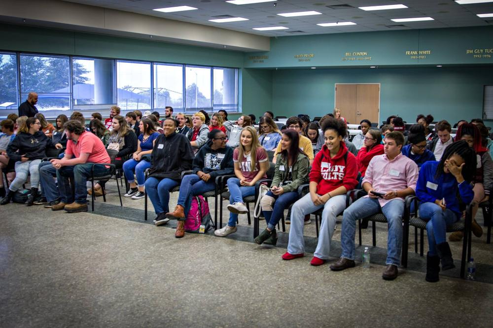 A large group of children sitting in a classroom