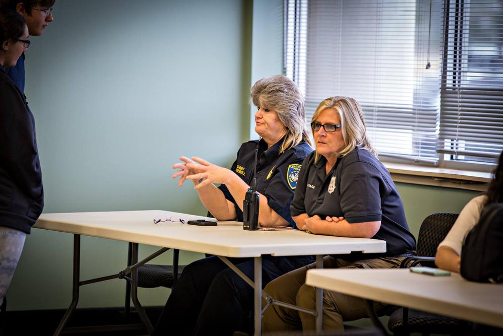 Two police officers sitting at a table