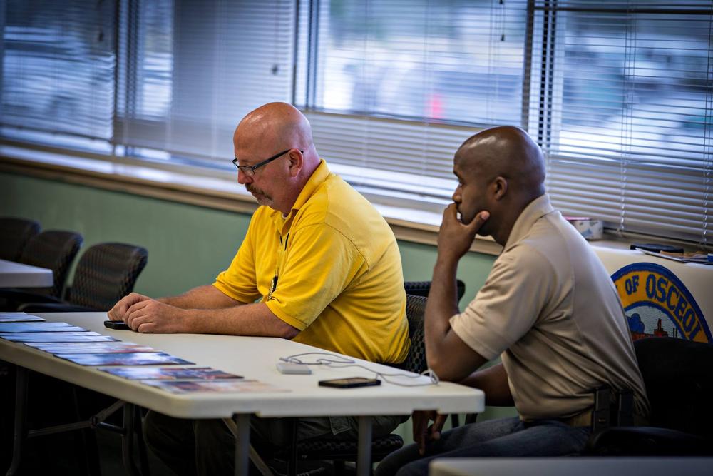 Two officers from the Osceola Police Department sitting at a table