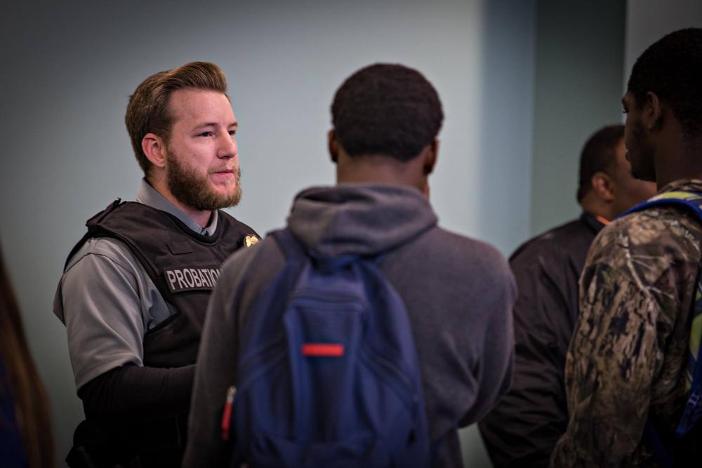 Students speaking with an Adult Probation and Parole officer