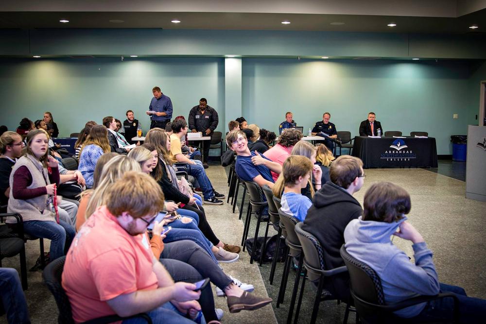 A room full of students sitting in chairs