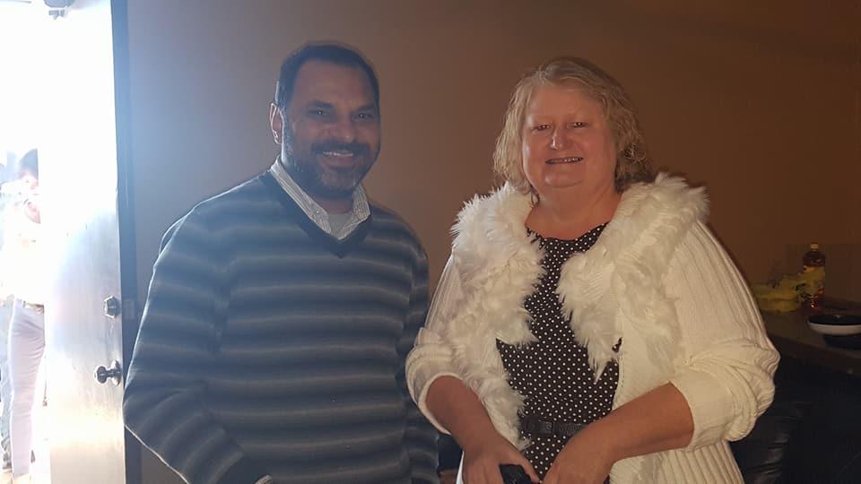 A man and a woman standing together and smiling for the camera